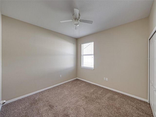 unfurnished bedroom with a closet, ceiling fan, baseboards, and carpet floors