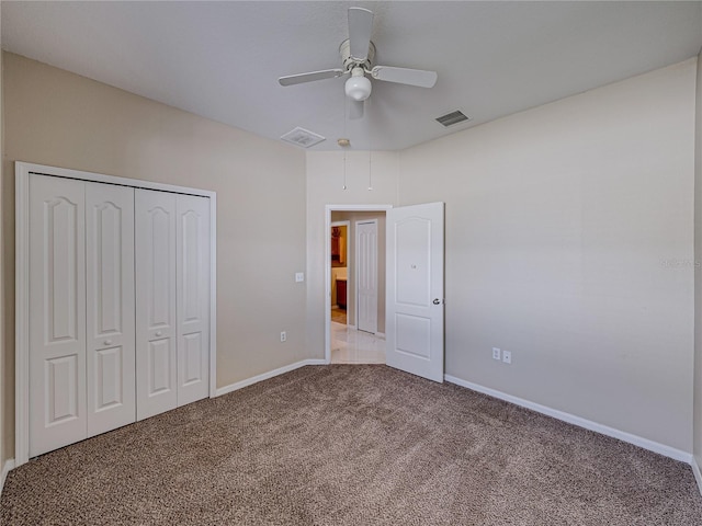 unfurnished bedroom featuring visible vents, a closet, carpet flooring, baseboards, and ceiling fan