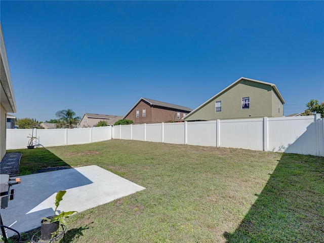 view of yard with a patio area and a fenced backyard