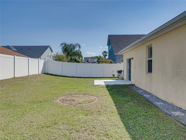 view of yard with a patio area and a fenced backyard