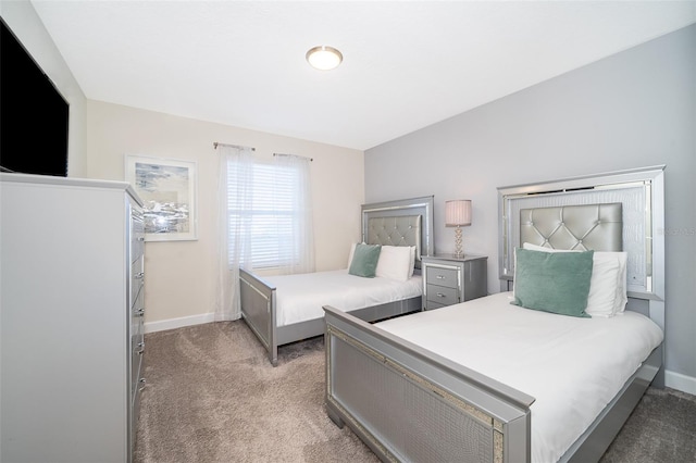 bedroom featuring baseboards and light colored carpet