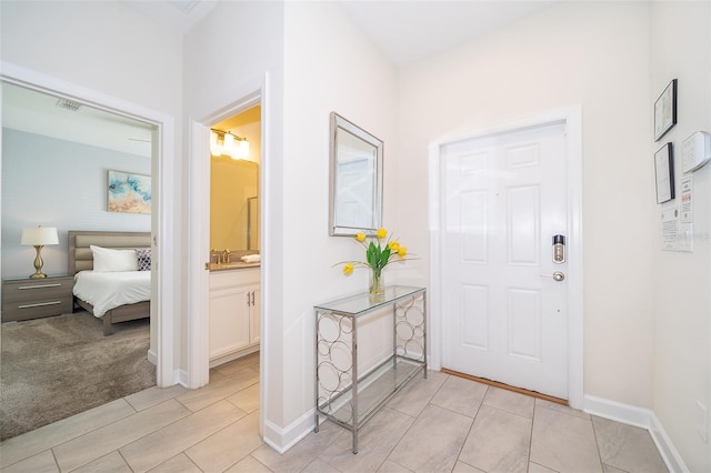 entryway with baseboards and visible vents
