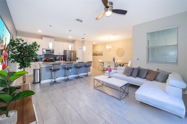 living area featuring recessed lighting, visible vents, and a ceiling fan