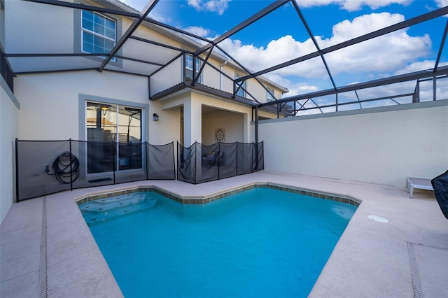 view of swimming pool with glass enclosure, a patio, and a fenced in pool