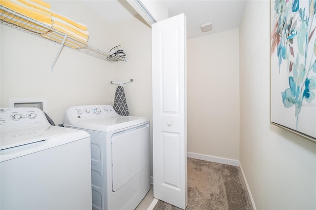 laundry area with baseboards, light carpet, independent washer and dryer, and laundry area