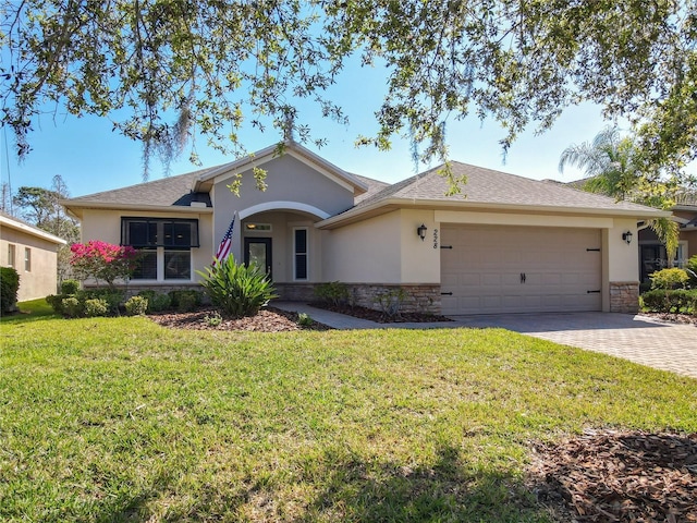 ranch-style house with an attached garage, stone siding, driveway, and stucco siding