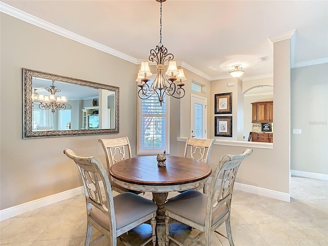 dining room with crown molding, a notable chandelier, baseboards, and light tile patterned floors