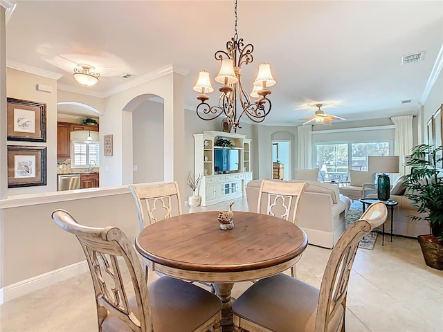 dining area featuring visible vents, ceiling fan with notable chandelier, arched walkways, crown molding, and light tile patterned floors