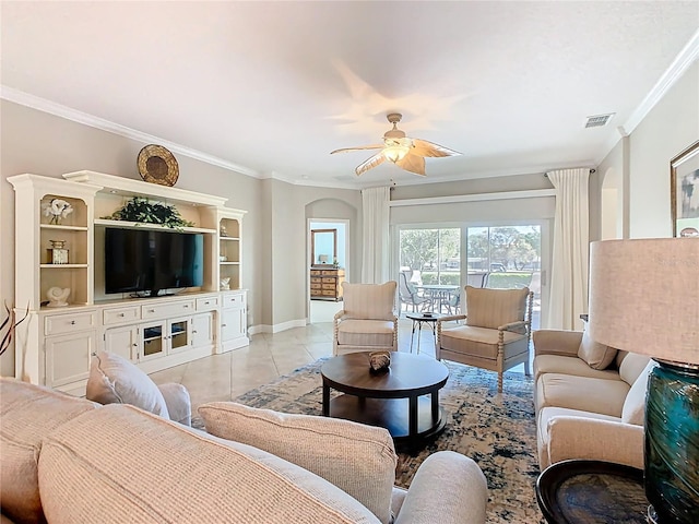 living room featuring visible vents, ornamental molding, light tile patterned floors, baseboards, and ceiling fan