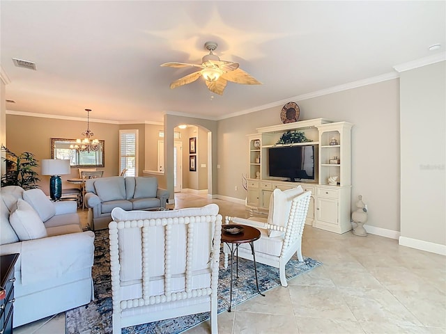 living room with visible vents, baseboards, ornamental molding, ceiling fan with notable chandelier, and arched walkways