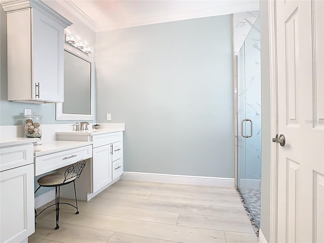 full bathroom with a marble finish shower, crown molding, baseboards, wood finished floors, and vanity