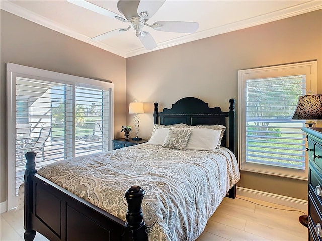 bedroom featuring baseboards, multiple windows, and ornamental molding