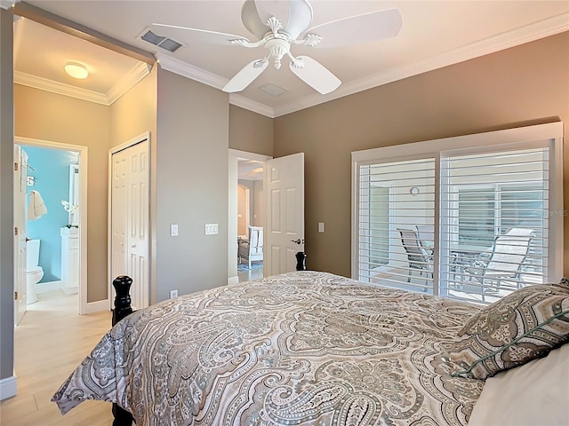 bedroom featuring a closet, visible vents, light wood-type flooring, and crown molding