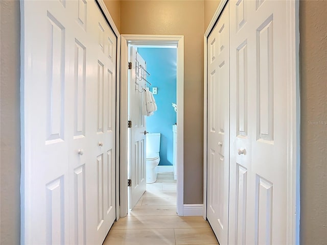 corridor featuring baseboards