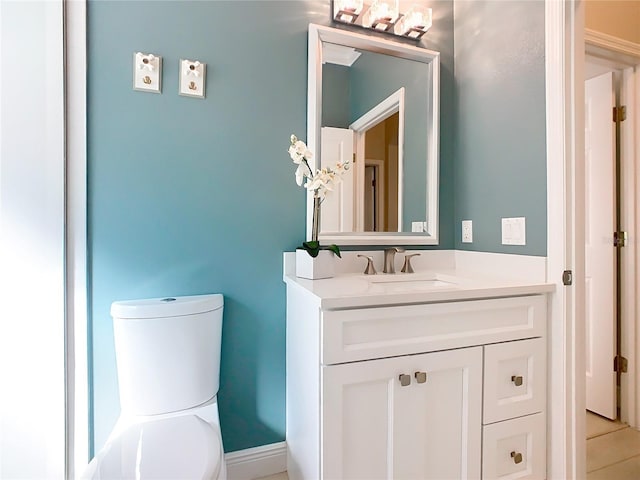 half bathroom featuring toilet and vanity