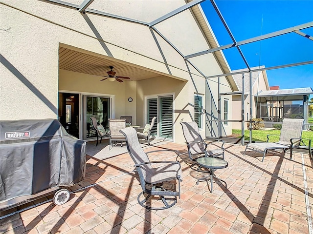 view of patio / terrace with a lanai, a grill, and a ceiling fan