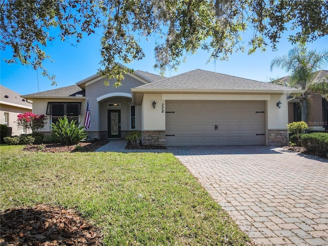 single story home with stone siding, stucco siding, and an attached garage