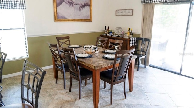 dining space with light tile patterned floors and baseboards