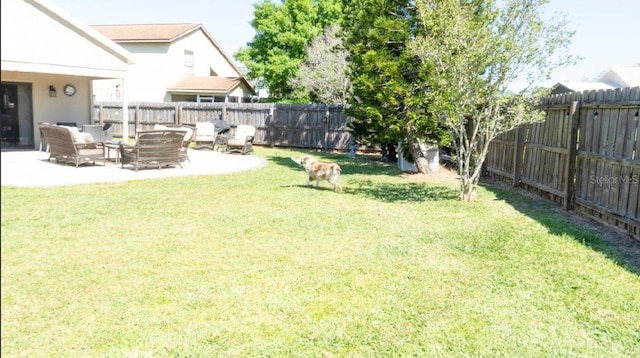 view of yard with a fenced backyard, outdoor lounge area, and a patio area