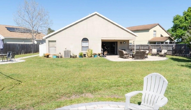 back of house with a patio area, central air condition unit, and a lawn