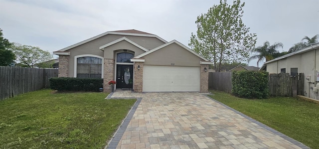 ranch-style home with brick siding, a front lawn, and decorative driveway