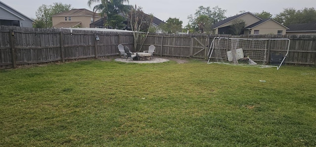 view of yard featuring a patio area, a fire pit, and a fenced backyard