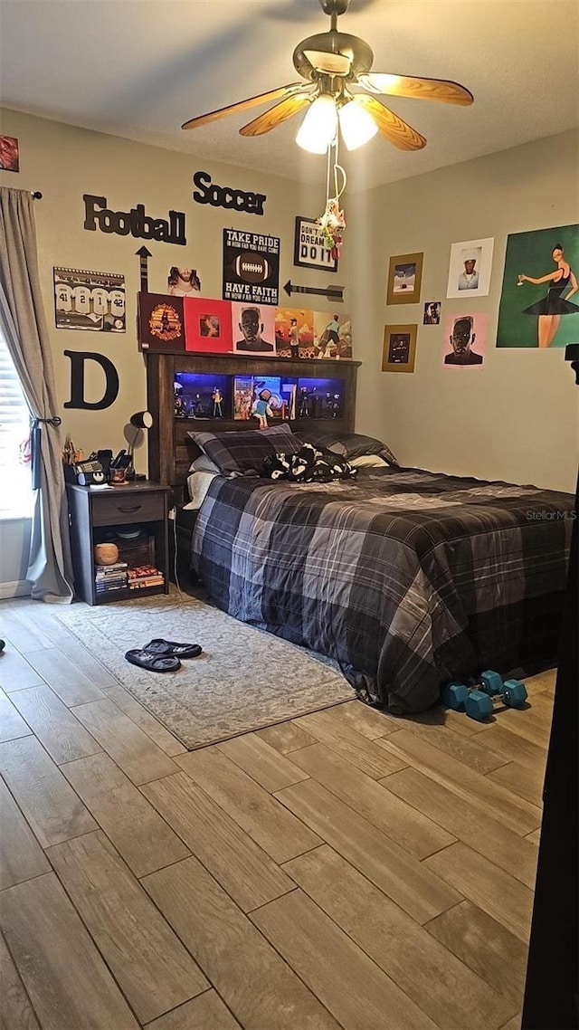 bedroom with ceiling fan and wood finished floors