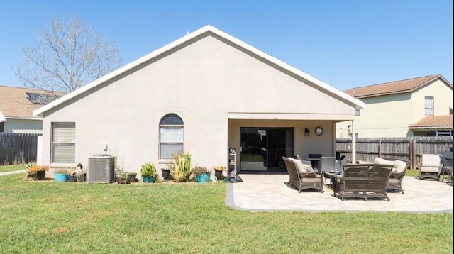 rear view of house with central AC, a yard, stucco siding, a patio, and fence
