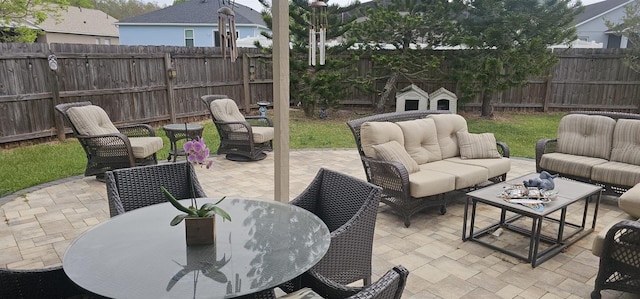 view of patio / terrace featuring an outdoor living space, outdoor dining area, and a fenced backyard