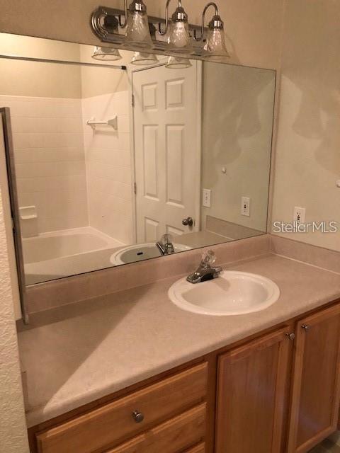 9061 Lee Vista Blvd Unit 1303, Orlando, FL 32829 - bathroom with vanity and a chandelier