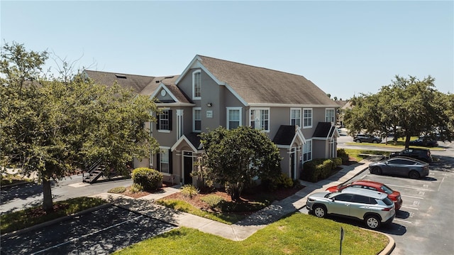 9061 Lee Vista Blvd Unit 1303, Orlando, FL 32829 - multi unit property featuring uncovered parking, a shingled roof, stucco siding, and stairs