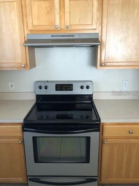 9061 Lee Vista Blvd Unit 1303, Orlando, FL 32829 - kitchen with stainless steel electric range oven, under cabinet range hood, and light countertops