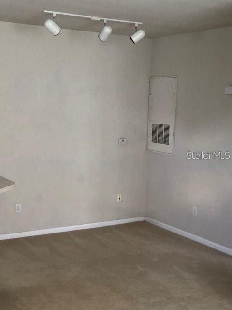9061 Lee Vista Blvd Unit 1303, Orlando, FL 32829 - carpeted spare room with rail lighting and baseboards