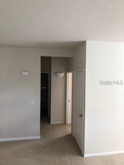 9061 Lee Vista Blvd Unit 1303, Orlando, FL 32829 - unfurnished room with light carpet and baseboards