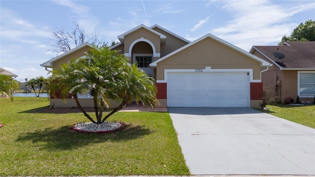 view of front of home featuring brick siding, concrete driveway, a front yard, stucco siding, and a garage