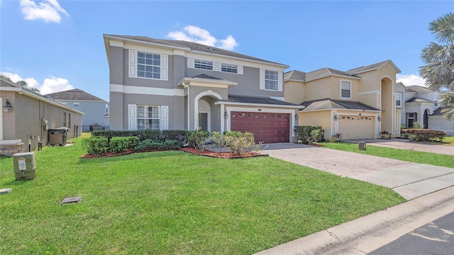 view of front of property featuring stucco siding, driveway, a front yard, and a garage