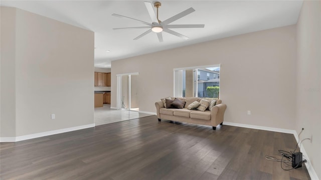 interior space with baseboards, light wood-style floors, and ceiling fan