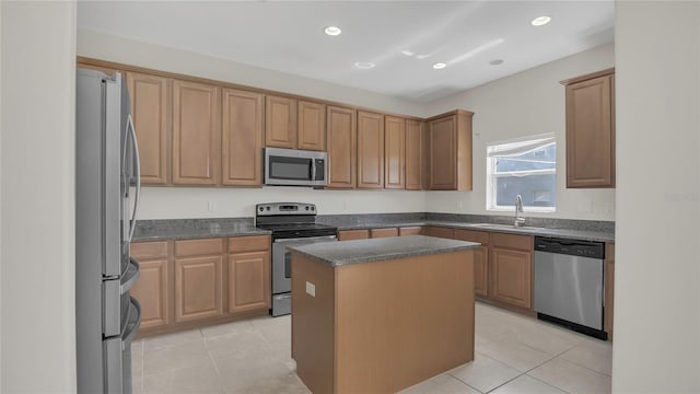 kitchen with a sink, appliances with stainless steel finishes, light tile patterned flooring, and recessed lighting