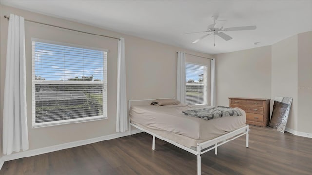 bedroom with a ceiling fan, baseboards, and wood finished floors