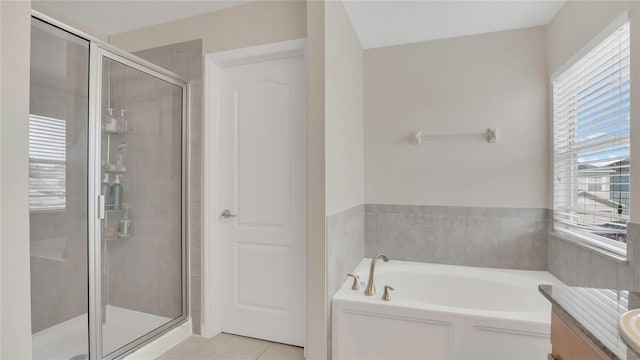 full bathroom with tile patterned flooring, a shower stall, a bath, and vanity