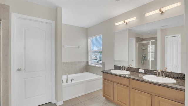 full bath with tile patterned flooring, a stall shower, a bath, and a sink