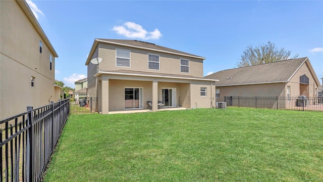 back of house with stucco siding, a lawn, central AC, a fenced backyard, and a patio area