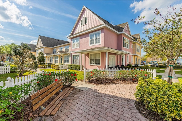 back of property featuring a fenced front yard and stucco siding