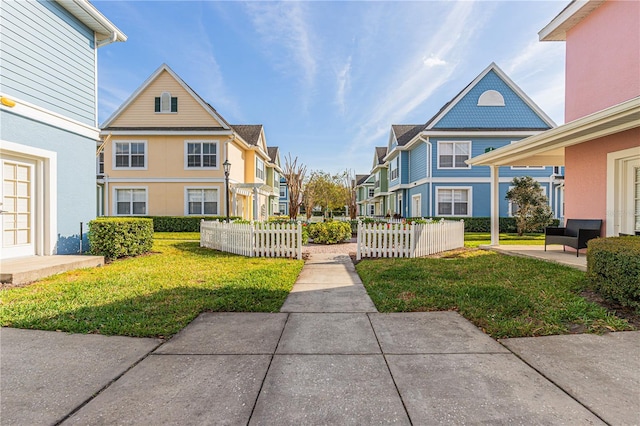 surrounding community featuring a patio area, a residential view, a lawn, and fence