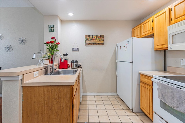 kitchen featuring white appliances, light tile patterned flooring, light countertops, and a sink