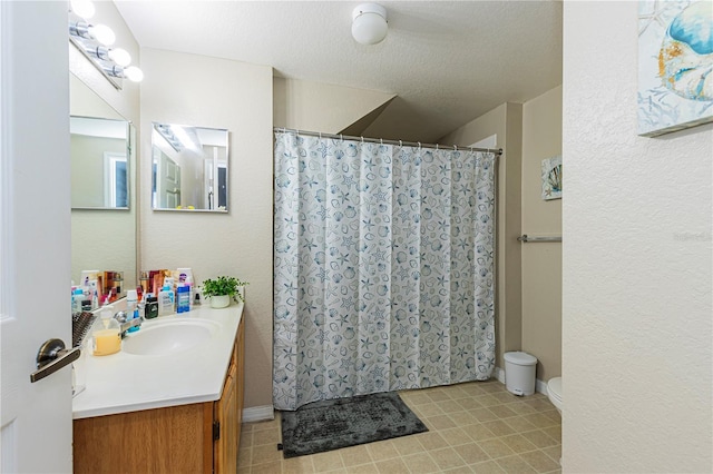 full bath with vanity, tile patterned flooring, a textured ceiling, curtained shower, and toilet