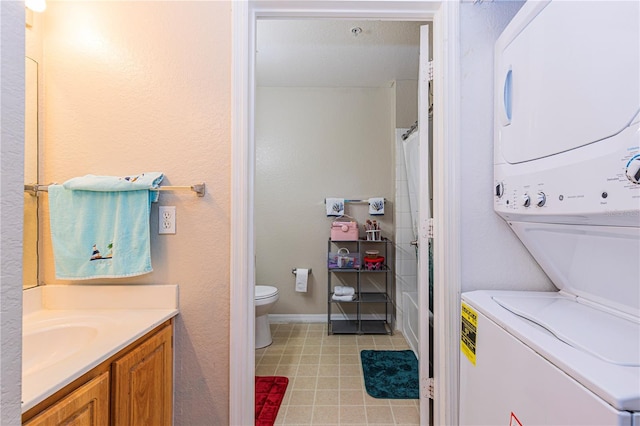 laundry room featuring light tile patterned flooring, stacked washer / dryer, laundry area, and a sink