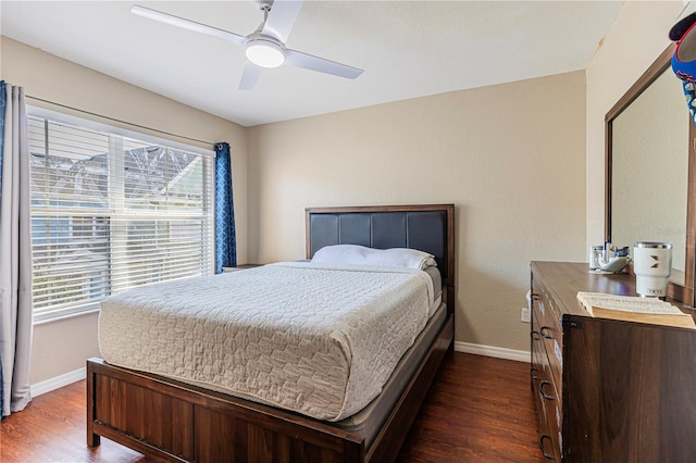 bedroom with baseboards, dark wood-style floors, and a ceiling fan