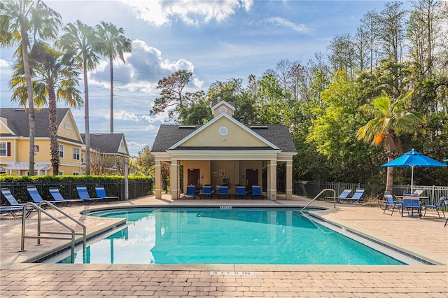 community pool featuring a patio and fence