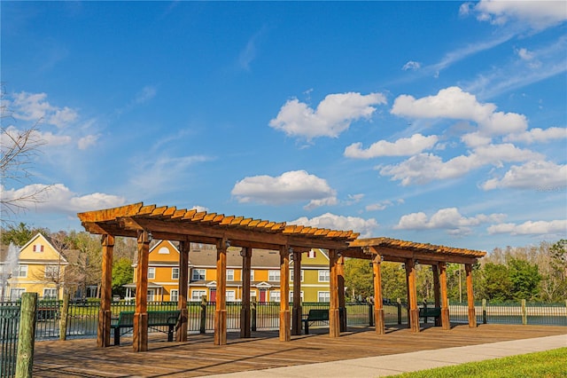 surrounding community with fence and a pergola